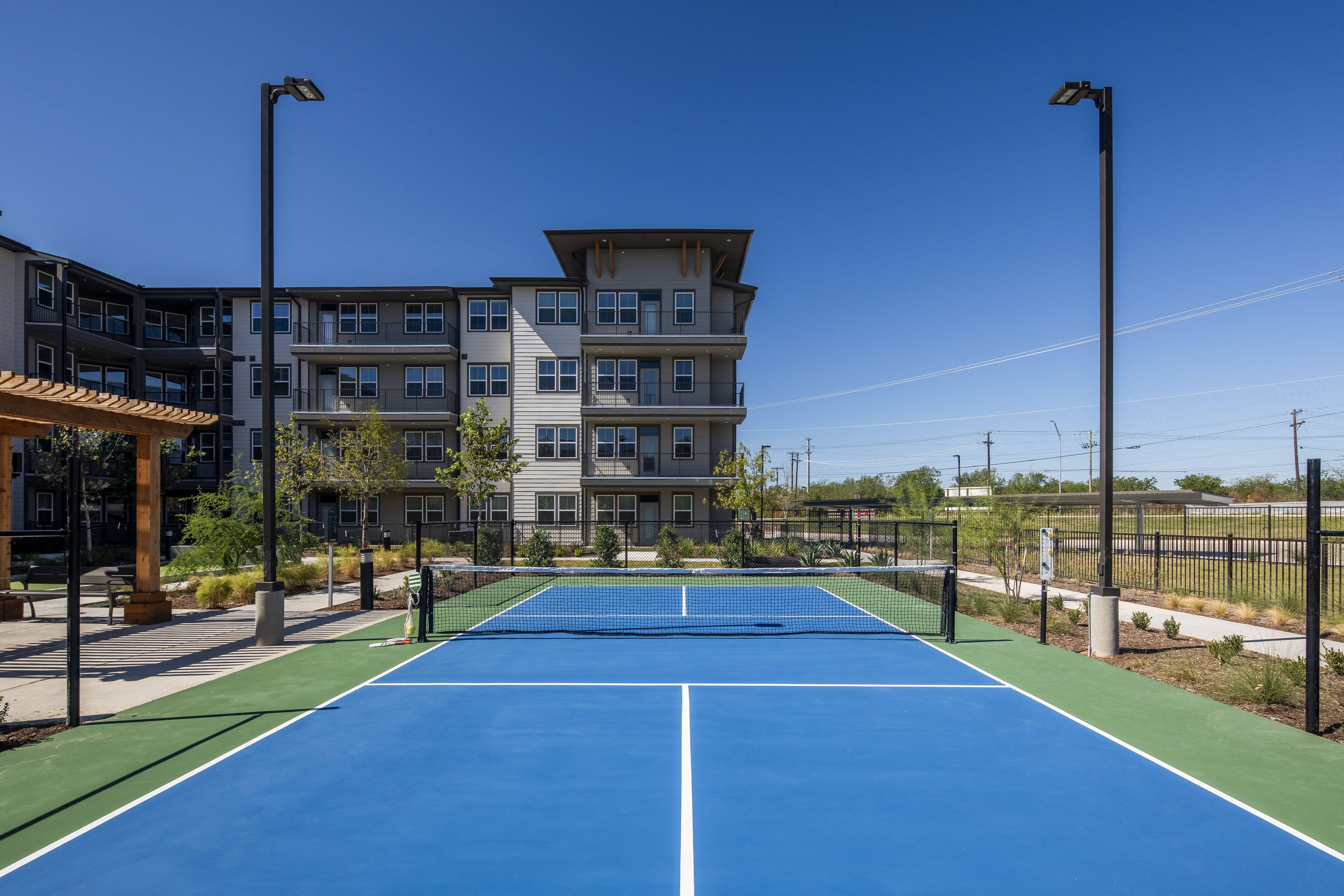 a ground level view of a pickleball court at a senior apartment community
